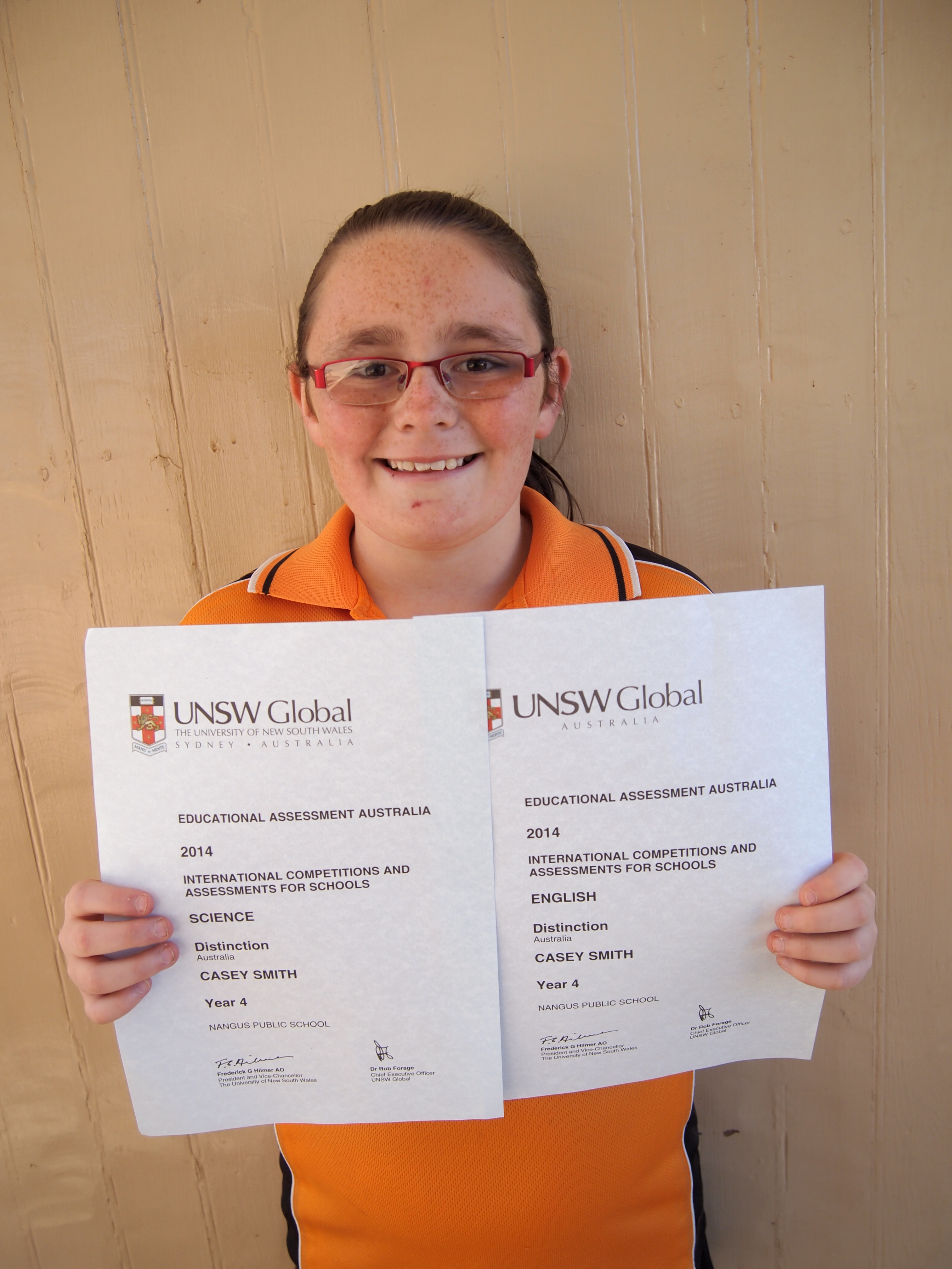 Casey proudly displaying her Certificates of Distinction